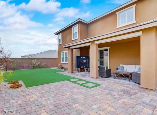 back of property featuring an outdoor living space, a patio, stucco siding, and fence
