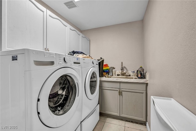 90 Ancient Hills Ln, Henderson, NV 89074 - laundry area featuring washing machine and dryer, cabinet space, and light tile patterned floors