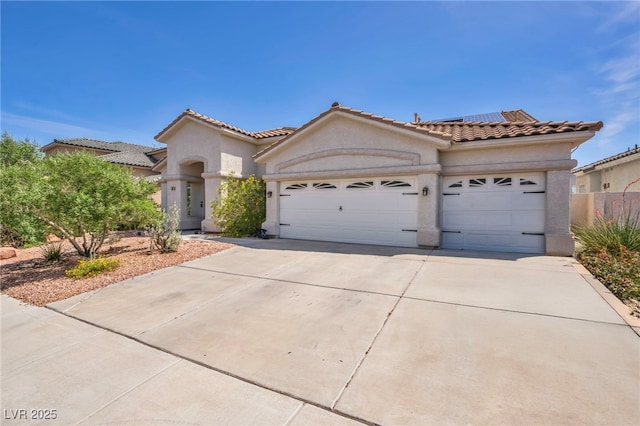 90 Ancient Hills Ln, Henderson, NV 89074 - mediterranean / spanish home with an attached garage, stucco siding, concrete driveway, and solar panels