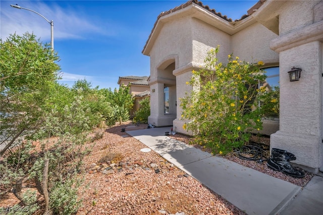 90 Ancient Hills Ln, Henderson, NV 89074 - view of side of property with stucco siding and a tile roof