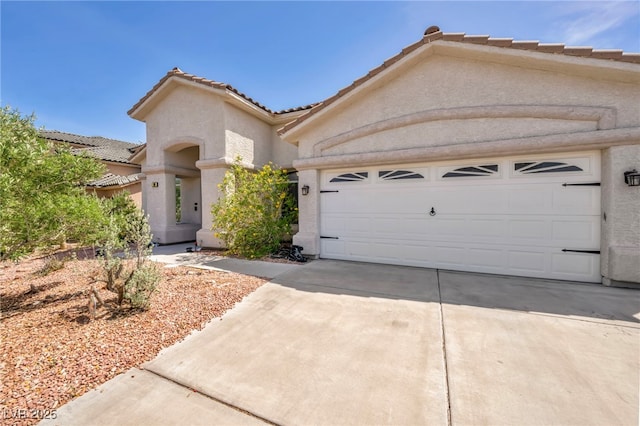 90 Ancient Hills Ln, Henderson, NV 89074 - view of front of property featuring a tile roof, stucco siding, driveway, and an attached garage