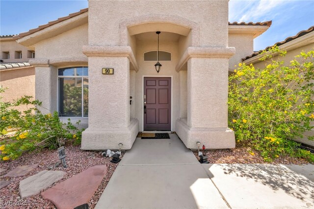 90 Ancient Hills Ln, Henderson, NV 89074 - property entrance with a tiled roof and stucco siding
