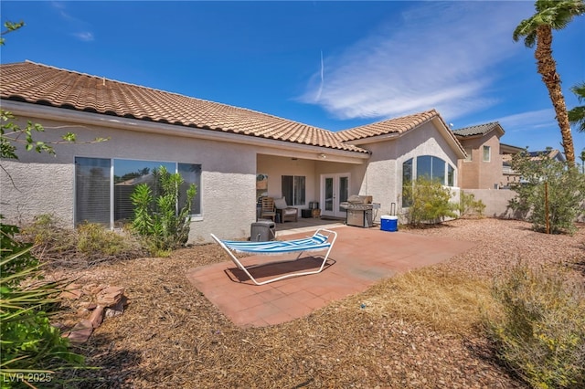 90 Ancient Hills Ln, Henderson, NV 89074 - rear view of property featuring french doors, stucco siding, a patio, and fence