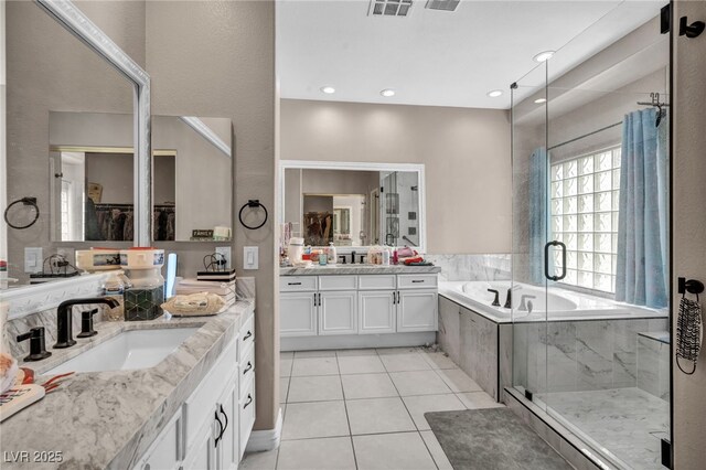 90 Ancient Hills Ln, Henderson, NV 89074 - bathroom featuring tile patterned floors, a bath, a stall shower, and two vanities