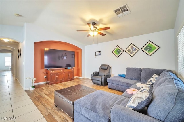 9383 Borough Park St, Las Vegas, NV 89178 - living area with plenty of natural light, visible vents, ceiling fan, arched walkways, and light wood finished floors