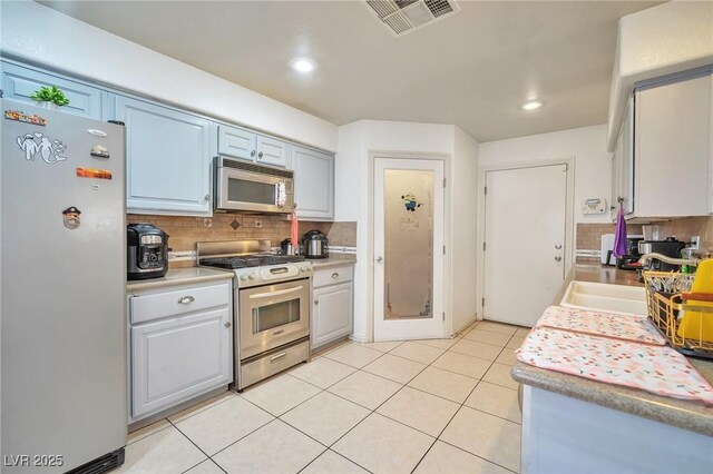 9383 Borough Park St, Las Vegas, NV 89178 - kitchen with tasteful backsplash, visible vents, light countertops, and appliances with stainless steel finishes