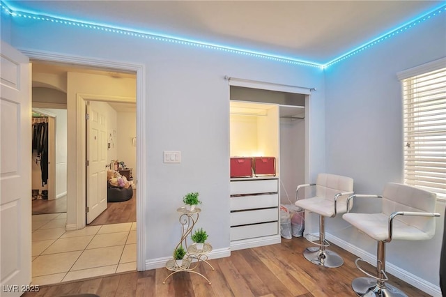 9383 Borough Park St, Las Vegas, NV 89178 - sitting room featuring baseboards, arched walkways, and light wood-style floors