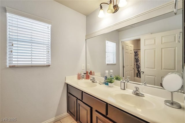 9383 Borough Park St, Las Vegas, NV 89178 - bathroom featuring a sink, tile patterned floors, double vanity, and baseboards
