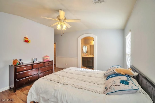 9383 Borough Park St, Las Vegas, NV 89178 - bedroom with visible vents, arched walkways, ceiling fan, light wood-type flooring, and wainscoting