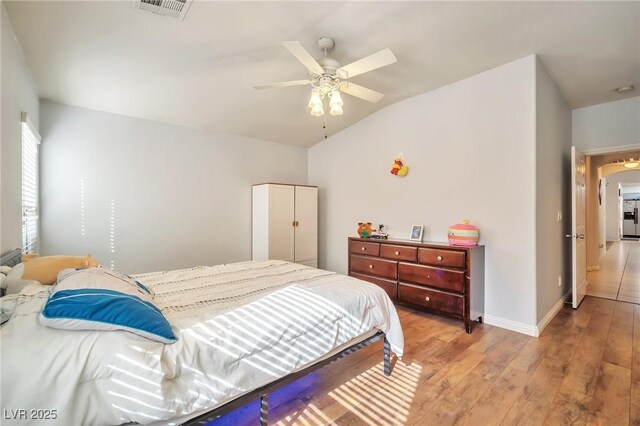 9383 Borough Park St, Las Vegas, NV 89178 - bedroom featuring baseboards, a ceiling fan, light wood-style floors, visible vents, and lofted ceiling