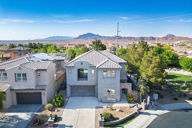 580 Via Di Parione Ct, Henderson, NV 89011 - mediterranean / spanish home featuring concrete driveway, stucco siding, a garage, and a mountain view