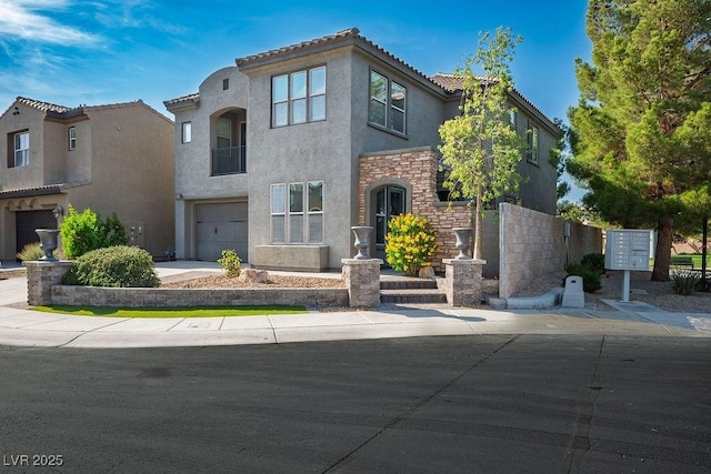 580 Via Di Parione Ct, Henderson, NV 89011 - view of front of home featuring a tiled roof, a garage, stucco siding, and stone siding
