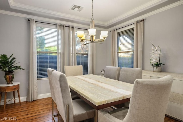 580 Via Di Parione Ct, Henderson, NV 89011 - dining room with hardwood / wood-style flooring, visible vents, an inviting chandelier, crown molding, and plenty of natural light
