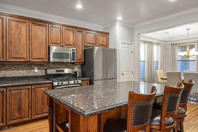 580 Via Di Parione Ct, Henderson, NV 89011 - kitchen with light wood-style flooring, open shelves, backsplash, appliances with stainless steel finishes, and a kitchen island