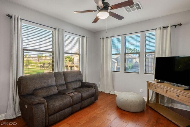 580 Via Di Parione Ct, Henderson, NV 89011 - living area featuring wood finished floors, visible vents, baseboards, and a healthy amount of sunlight