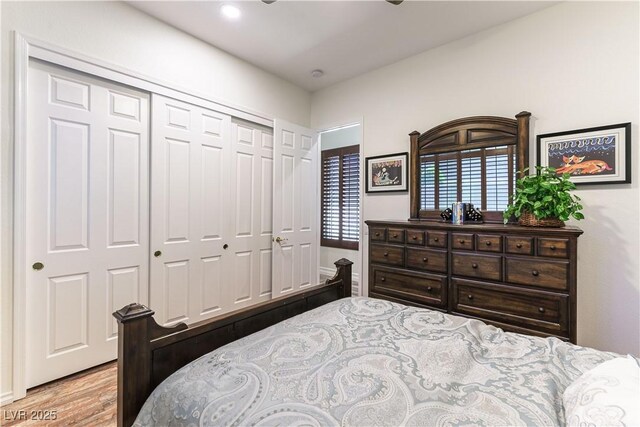 bedroom with recessed lighting, a closet, and light wood-type flooring