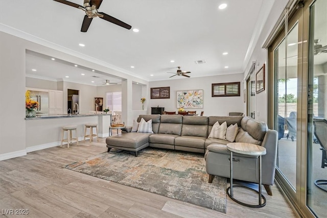 living room with recessed lighting, ceiling fan, and crown molding