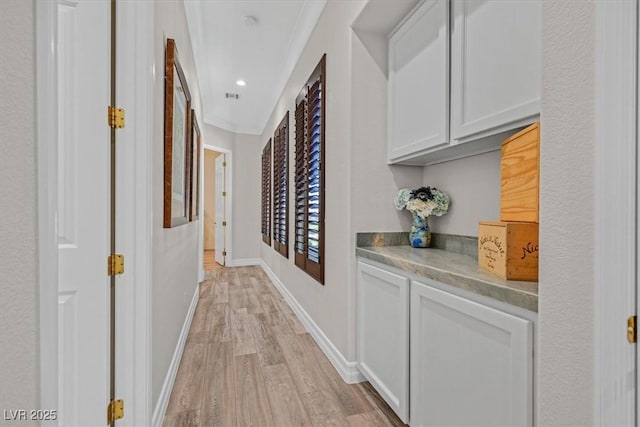 hall featuring recessed lighting, visible vents, baseboards, and light wood-style floors