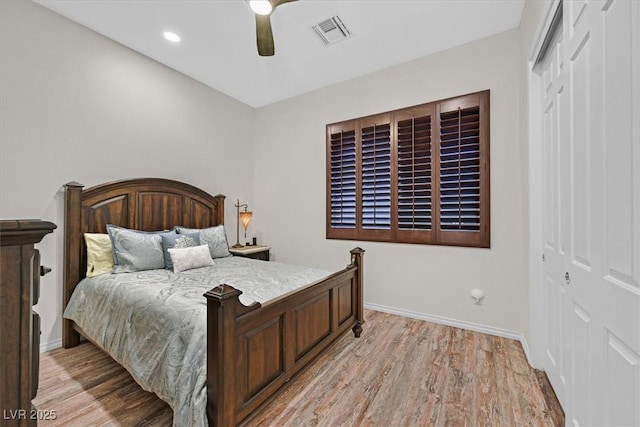 bedroom featuring visible vents, light wood-type flooring, baseboards, and a closet