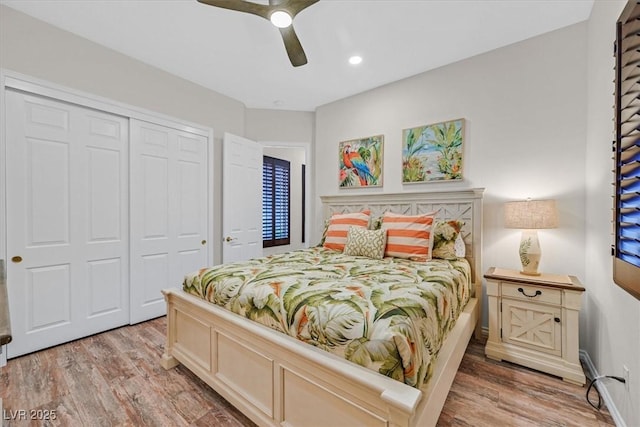 bedroom with light wood finished floors, a closet, ceiling fan, and recessed lighting