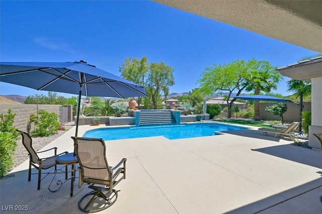 view of swimming pool featuring a patio, a fenced in pool, and a fenced backyard