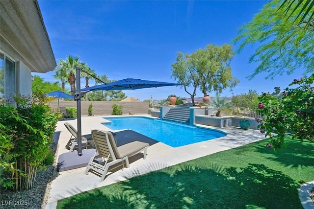 view of pool with a patio, a fenced backyard, a yard, and a fenced in pool