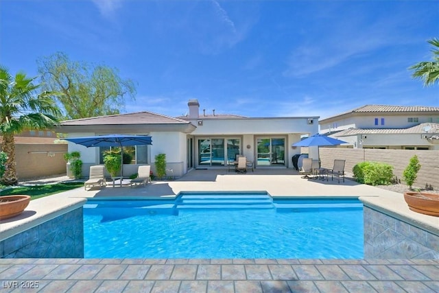 view of swimming pool with a patio, fence, and a fenced in pool