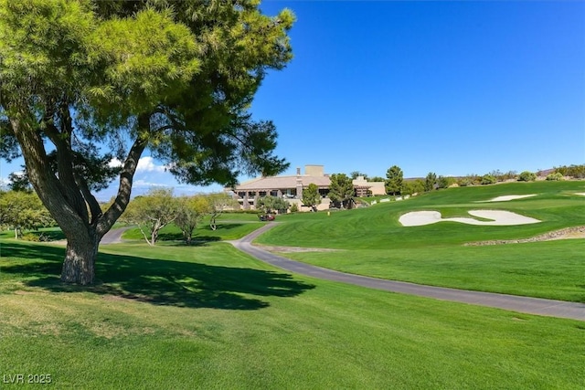 surrounding community featuring a yard and view of golf course
