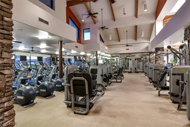 exercise room featuring visible vents, a ceiling fan, carpet flooring, and high vaulted ceiling