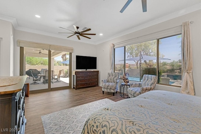 bedroom featuring wood finished floors, crown molding, access to outside, and multiple windows