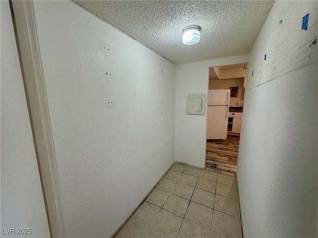 3930 University Center Dr Unit 409, Las Vegas, NV 89119 - hallway featuring a textured ceiling and light tile patterned floors