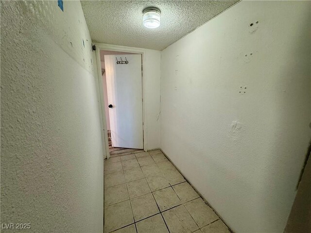 3930 University Center Dr Unit 409, Las Vegas, NV 89119 - hall with a textured ceiling, light tile patterned floors, and a textured wall