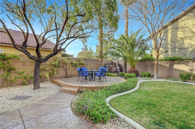 view of yard featuring a patio area and a fenced backyard