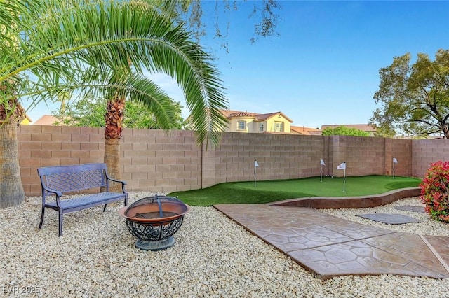 view of patio / terrace featuring an outdoor fire pit and a fenced backyard