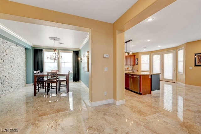 dining room with ornamental molding, baseboards, marble finish floor, and a chandelier