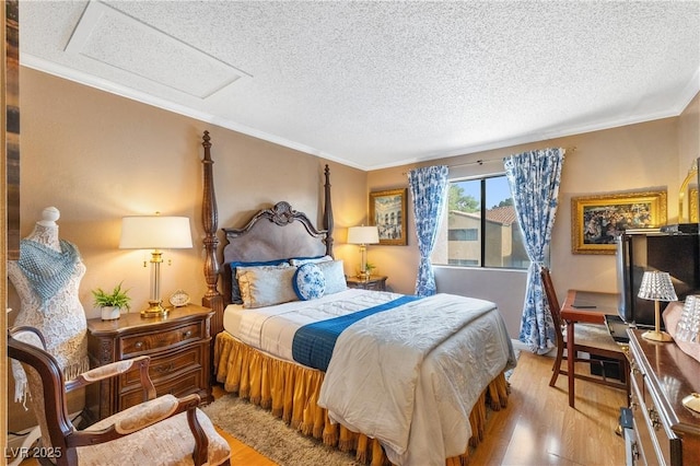 3151 Soaring Gulls Dr Unit 2035, Las Vegas, NV 89128 - bedroom with wood finished floors, a textured ceiling, attic access, and crown molding