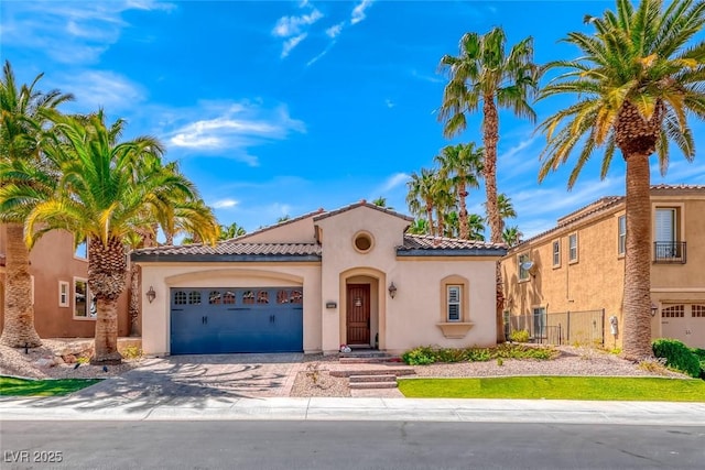 1045 Via Camelia St, Henderson, NV 89011 - mediterranean / spanish home with a tiled roof, an attached garage, fence, stucco siding, and driveway