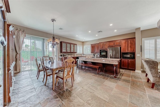 1045 Via Camelia St, Henderson, NV 89011 - dining space featuring stone tile flooring, a wealth of natural light, recessed lighting, and visible vents
