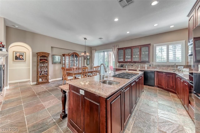 1045 Via Camelia St, Henderson, NV 89011 - kitchen with dishwasher, visible vents, a sink, and stone tile flooring