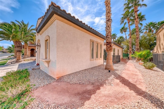 1045 Via Camelia St, Henderson, NV 89011 - view of side of property featuring fence and stucco siding