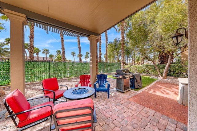 1045 Via Camelia St, Henderson, NV 89011 - view of patio / terrace with a fenced backyard, a grill, and a fire pit