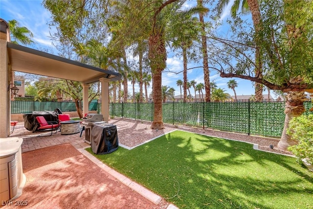 1045 Via Camelia St, Henderson, NV 89011 - view of yard featuring a patio, a fenced backyard, and a fire pit