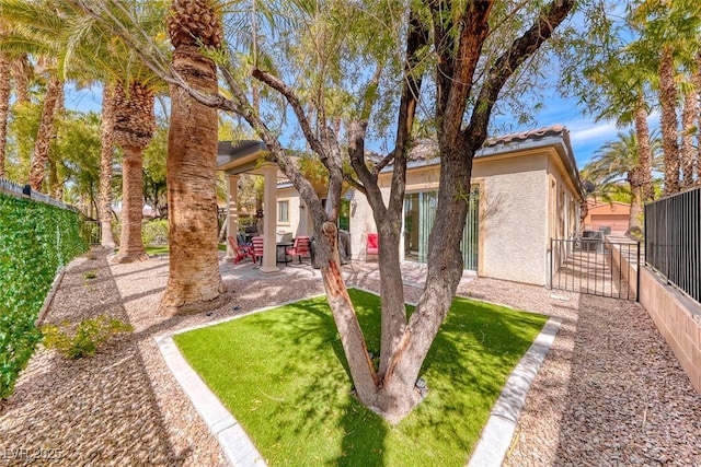 1045 Via Camelia St, Henderson, NV 89011 - exterior space featuring a patio, a tiled roof, a fenced backyard, and stucco siding