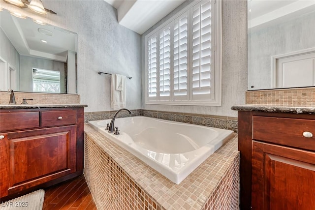 1045 Via Camelia St, Henderson, NV 89011 - full bathroom featuring decorative backsplash, a bath, wood finished floors, and vanity
