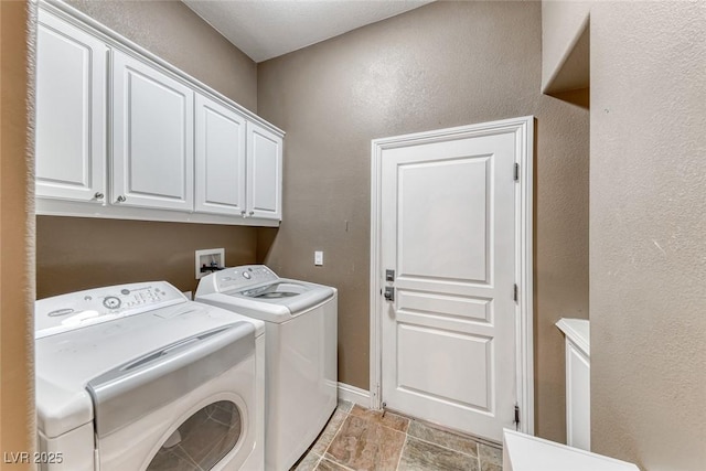 1045 Via Camelia St, Henderson, NV 89011 - washroom with separate washer and dryer, baseboards, a textured wall, cabinet space, and stone finish flooring