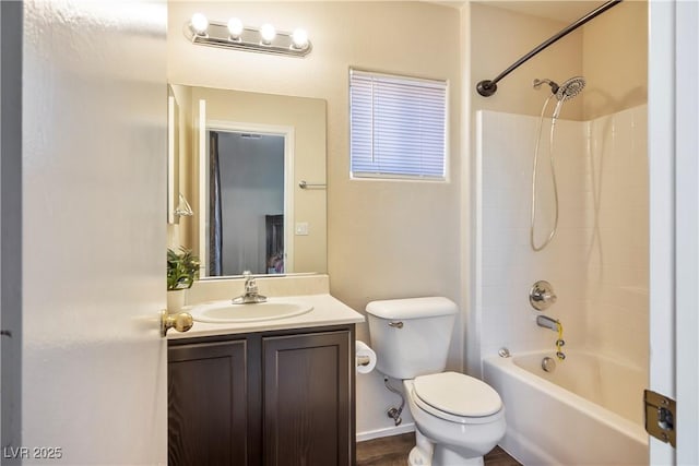 bathroom featuring toilet, vanity, and shower / bathing tub combination