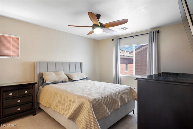 bedroom featuring visible vents, ceiling fan, and light colored carpet