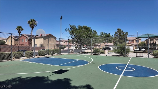 view of sport court with community basketball court, fence, and a residential view