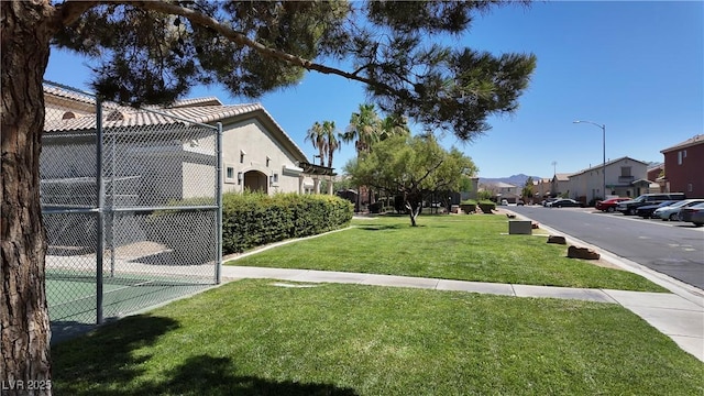 view of yard featuring fence and a residential view