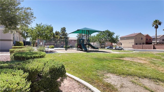 view of yard with fence, a residential view, and playground community